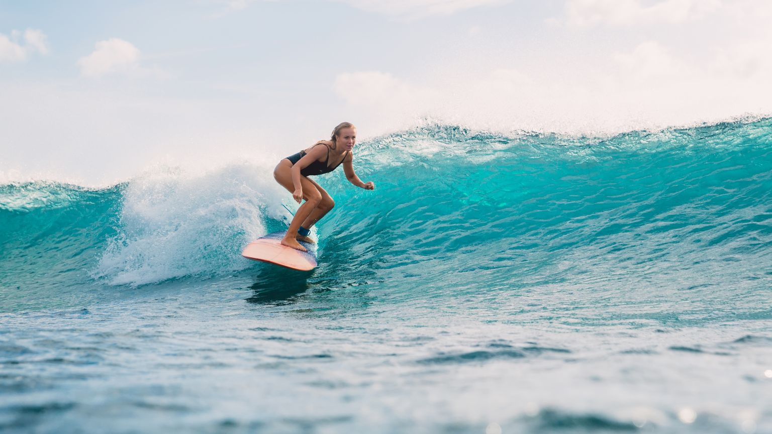 woman having a surf class, with empowerment, community and freedom in women’s surf culture