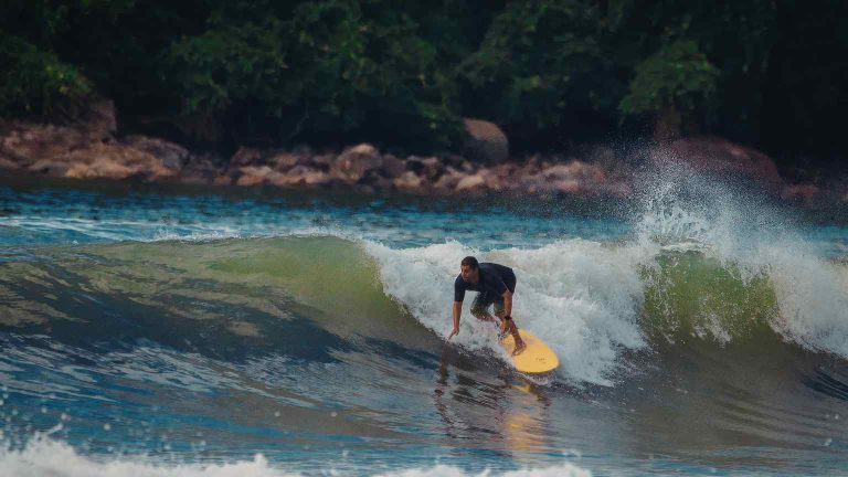 Surf in Tenerife at Playa de las Américas with surfers riding Atlantic waves